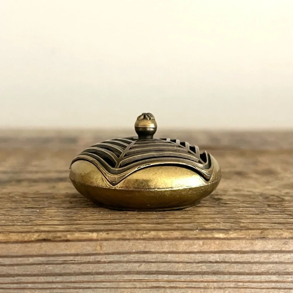 Brass spiderweb incense holder.